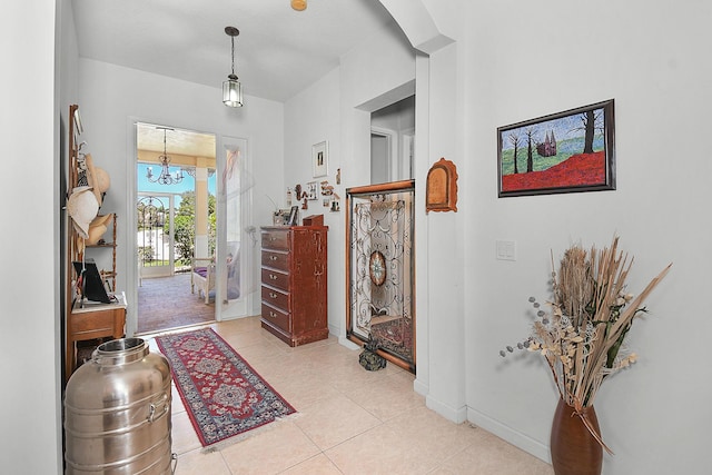 107 NW Summerville Ct, Port Saint Lucie, FL 34986 - foyer entrance featuring light tile patterned floors and a chandelier