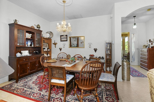107 NW Summerville Ct, Port Saint Lucie, FL 34986 - dining area with arched walkways, light tile patterned floors, and a chandelier