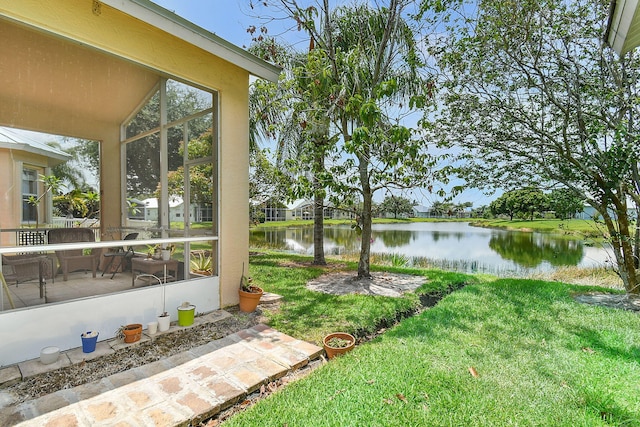 107 NW Summerville Ct, Port Saint Lucie, FL 34986 - view of green lawn with a water view and a sunroom