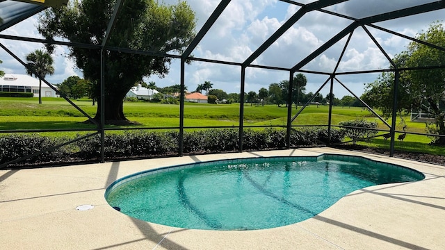 4575 SW Bimini Cir S, Palm City, FL 34990 - swimming pool with glass enclosure, a patio area, and a lawn