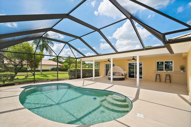 4575 SW Bimini Cir S, Palm City, FL 34990 - swimming pool with a patio, a ceiling fan, and glass enclosure