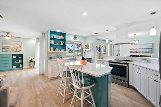 4575 SW Bimini Cir S, Palm City, FL 34990 - kitchen featuring stainless steel range with electric stovetop, island exhaust hood, a kitchen island, white cabinets, and recessed lighting
