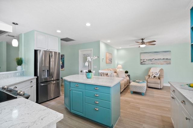4575 SW Bimini Cir S, Palm City, FL 34990 - kitchen with stainless steel refrigerator with ice dispenser, white cabinets, ceiling fan, light wood-style flooring, and recessed lighting