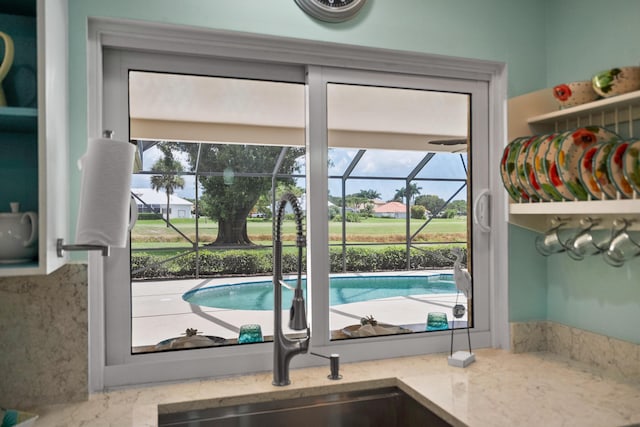 4575 SW Bimini Cir S, Palm City, FL 34990 - kitchen featuring healthy amount of natural light, light stone counters, and a sunroom