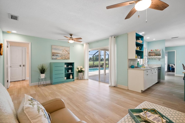 4575 SW Bimini Cir S, Palm City, FL 34990 - living area featuring ceiling fan, light wood finished floors, recessed lighting, and a textured ceiling