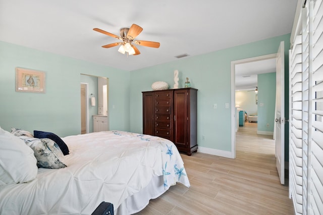 4575 SW Bimini Cir S, Palm City, FL 34990 - bedroom featuring light wood finished floors, ceiling fan, and connected bathroom