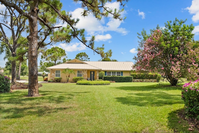 4575 SW Bimini Cir S, Palm City, FL 34990 - single story home with a front yard, stone siding, and a metal roof