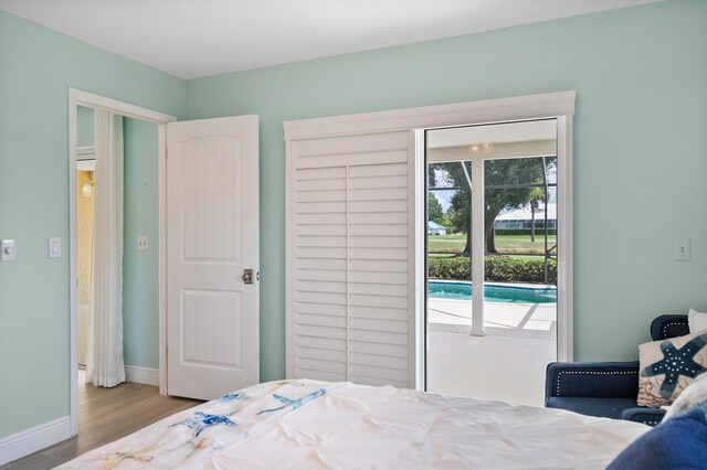 4575 SW Bimini Cir S, Palm City, FL 34990 - bedroom with wood finished floors and access to outside