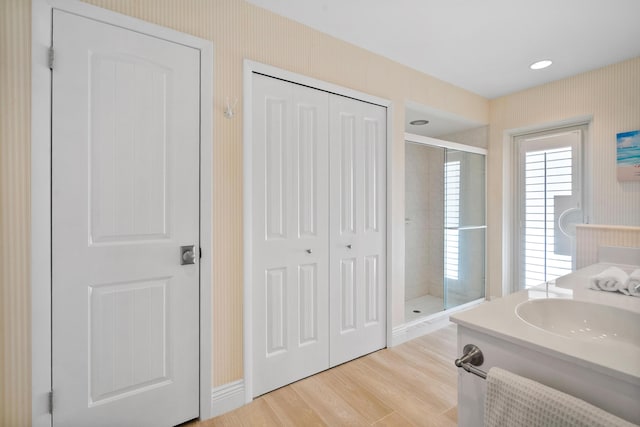 4575 SW Bimini Cir S, Palm City, FL 34990 - full bath with a stall shower, wood finished floors, vanity, wallpapered walls, and a closet