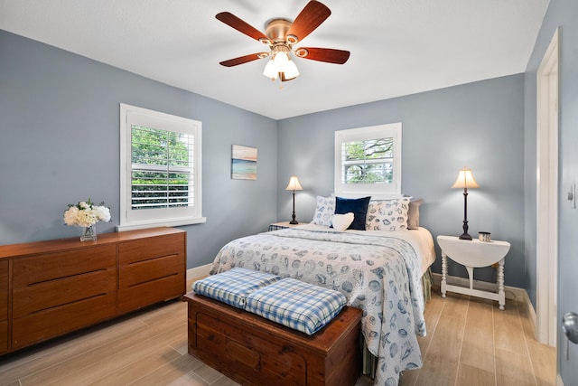 4575 SW Bimini Cir S, Palm City, FL 34990 - bedroom with light wood finished floors and a ceiling fan