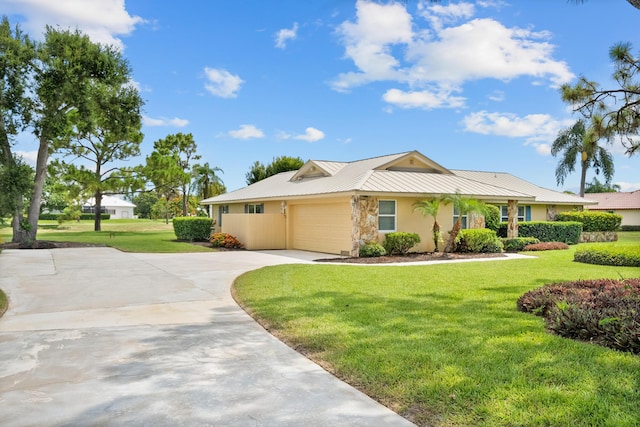 4575 SW Bimini Cir S, Palm City, FL 34990 - ranch-style home with concrete driveway, a garage, a front yard, stucco siding, and a metal roof