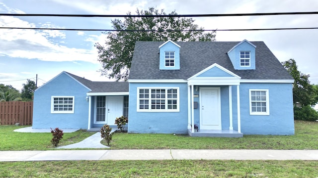 307 4th St, Lake Park, FL 33403 - cape cod house featuring stucco siding and a shingled roof