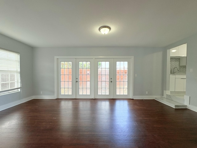 307 4th St, Lake Park, FL 33403 - unfurnished room with dark wood-type flooring, baseboards, and french doors
