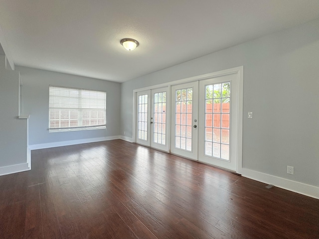 307 4th St, Lake Park, FL 33403 - spare room featuring baseboards, dark wood finished floors, and french doors