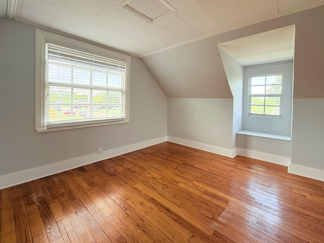 307 4th St, Lake Park, FL 33403 - additional living space featuring vaulted ceiling, hardwood / wood-style flooring, and baseboards