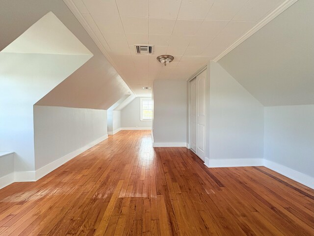 307 4th St, Lake Park, FL 33403 - bonus room featuring hardwood / wood-style floors, vaulted ceiling, and baseboards