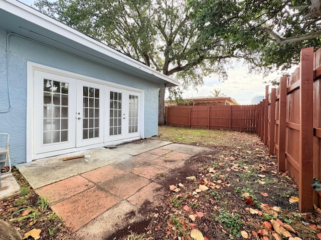 307 4th St, Lake Park, FL 33403 - fenced backyard with french doors and a patio area