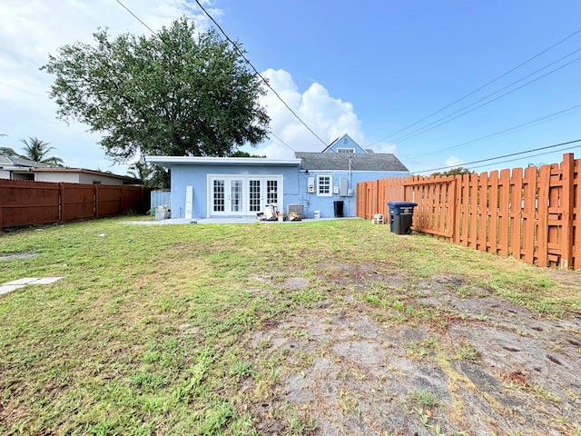 307 4th St, Lake Park, FL 33403 - rear view of house featuring french doors and stucco siding