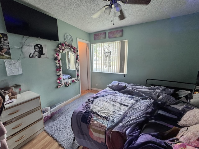 8700 NW 46th Ct, Lauderhill, FL 33351 - bedroom with wood finished floors, a textured ceiling, and ceiling fan