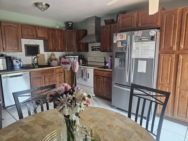 8700 NW 46th Ct, Lauderhill, FL 33351 - kitchen featuring appliances with stainless steel finishes, wall chimney range hood, a sink, and tasteful backsplash