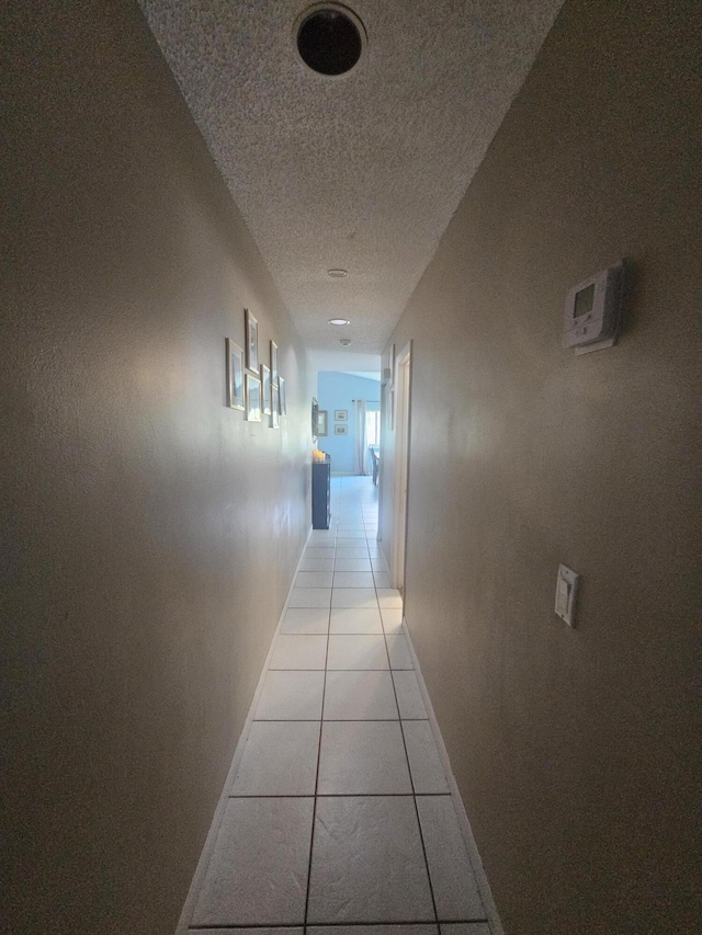 8700 NW 46th Ct, Lauderhill, FL 33351 - hall with light tile patterned flooring, a textured ceiling, and baseboards