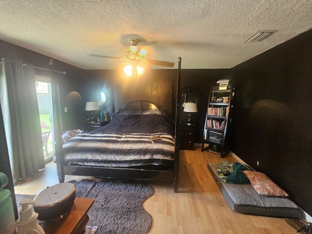 8700 NW 46th Ct, Lauderhill, FL 33351 - bedroom featuring wood finished floors, a textured ceiling, and a ceiling fan