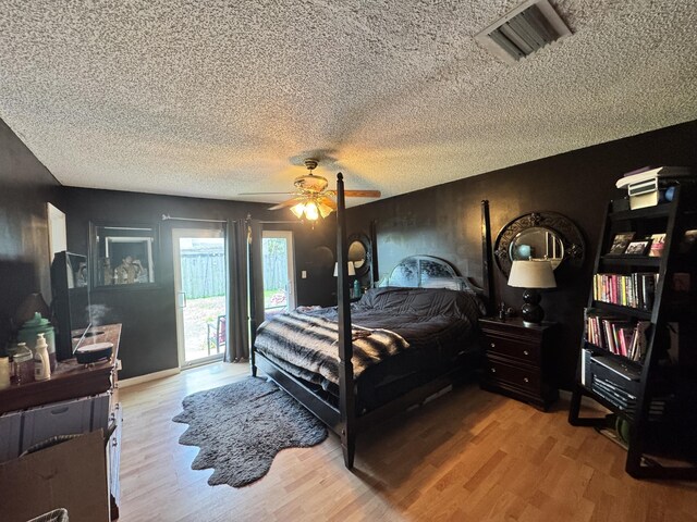 8700 NW 46th Ct, Lauderhill, FL 33351 - bedroom featuring access to outside, wood finished floors, a textured ceiling, and ceiling fan