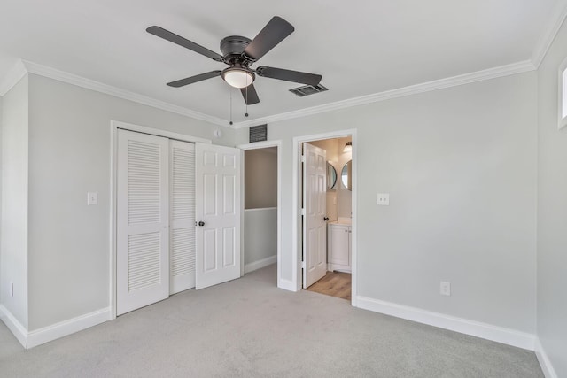 3322 Monterey Square Ln Unit 104, Fort Pierce, FL 34982 - unfurnished bedroom with crown molding, light carpet, a closet, and baseboards