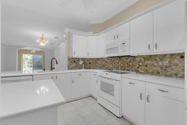 10664 Royal Caribbean Cir, Boynton Beach, FL 33437 - kitchen with white appliances, a sink, arched walkways, light countertops, and crown molding