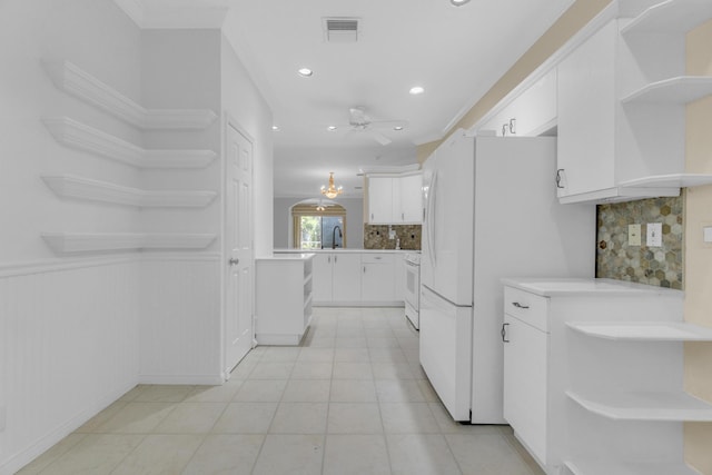 10664 Royal Caribbean Cir, Boynton Beach, FL 33437 - kitchen with open shelves, backsplash, white cabinetry, white appliances, and recessed lighting