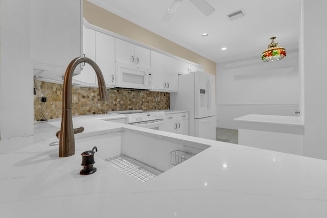 10664 Royal Caribbean Cir, Boynton Beach, FL 33437 - kitchen featuring white appliances, tasteful backsplash, white cabinets, and recessed lighting