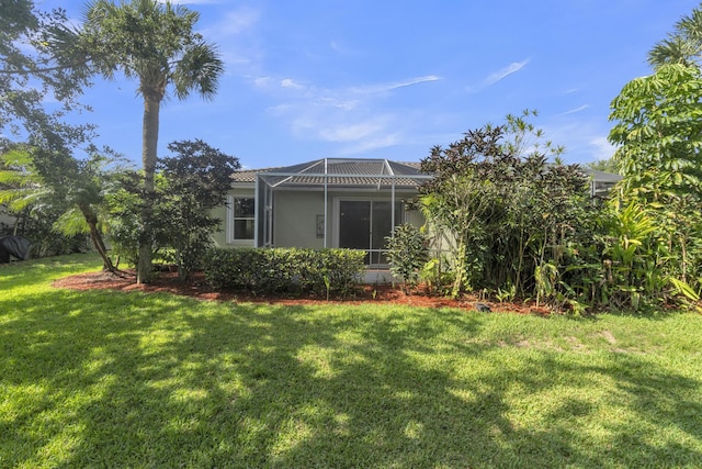 10664 Royal Caribbean Cir, Boynton Beach, FL 33437 - view of green lawn with a lanai