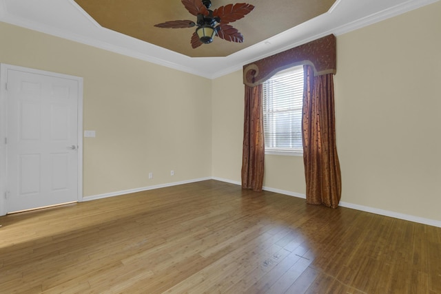 10664 Royal Caribbean Cir, Boynton Beach, FL 33437 - empty room with a ceiling fan, wood finished floors, a tray ceiling, ornamental molding, and baseboards