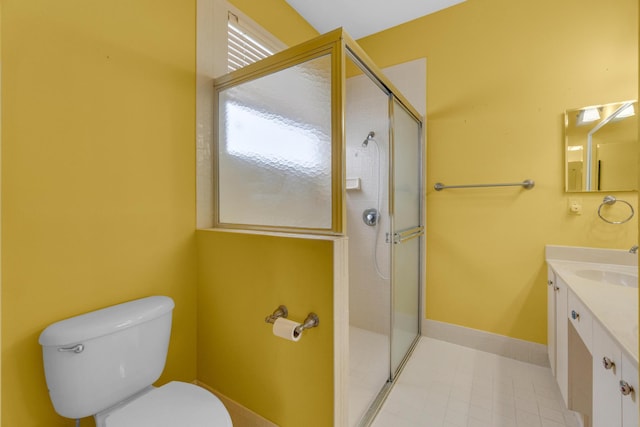 10664 Royal Caribbean Cir, Boynton Beach, FL 33437 - bathroom featuring toilet, vanity, a stall shower, tile patterned floors, and baseboards