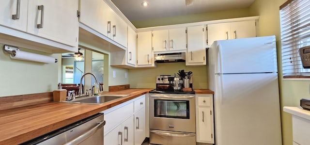 4299 NW 16th St Unit 303, Lauderhill, FL 33313 - kitchen featuring appliances with stainless steel finishes, under cabinet range hood, a sink, wooden counters, and white cabinetry