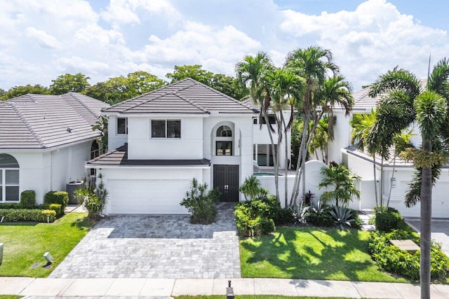 5779 Regency Cir W, Boca Raton, FL 33496 - view of front of home featuring stucco siding, a tiled roof, decorative driveway, and a garage