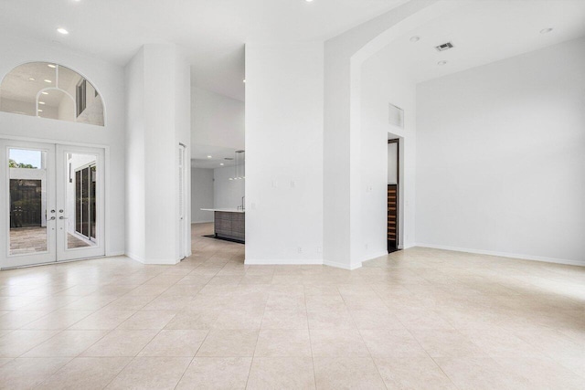 5779 Regency Cir W, Boca Raton, FL 33496 - unfurnished room featuring recessed lighting, a towering ceiling, french doors, light tile patterned flooring, and baseboards