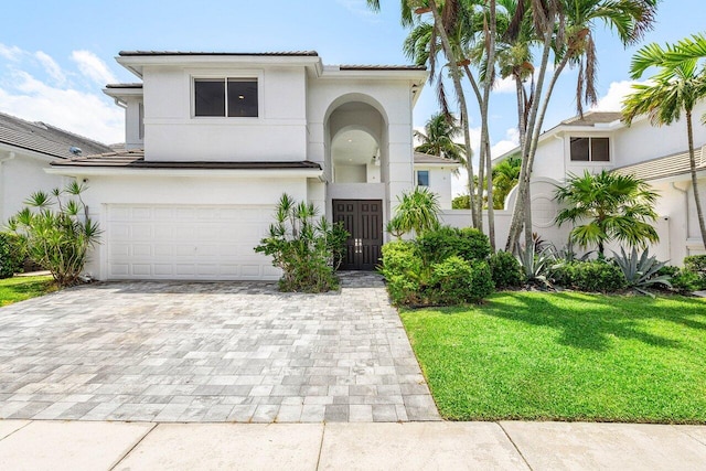 5779 Regency Cir W, Boca Raton, FL 33496 - view of front of house with a garage, decorative driveway, stucco siding, and a front lawn