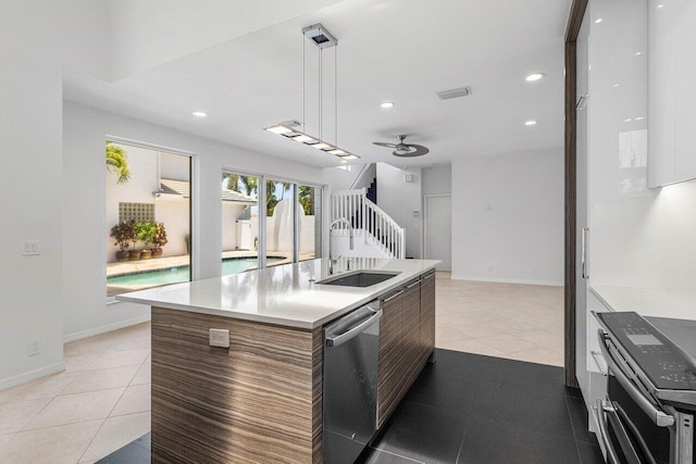5779 Regency Cir W, Boca Raton, FL 33496 - kitchen featuring appliances with stainless steel finishes, modern cabinets, a sink, a ceiling fan, and light tile patterned flooring