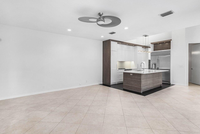 5779 Regency Cir W, Boca Raton, FL 33496 - kitchen featuring stainless steel built in fridge, ceiling fan, light countertops, open floor plan, and an island with sink