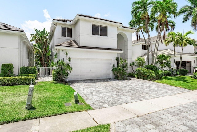 5779 Regency Cir W, Boca Raton, FL 33496 - view of front of home featuring a tile roof, a garage, driveway, a front yard, and stucco siding