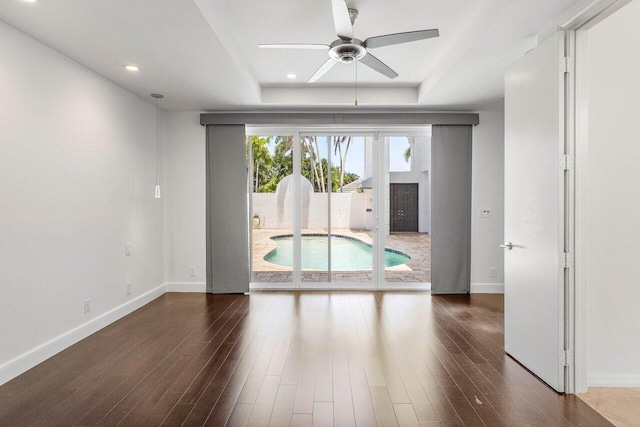 5779 Regency Cir W, Boca Raton, FL 33496 - spare room with a ceiling fan, baseboards, a tray ceiling, dark wood-style floors, and recessed lighting