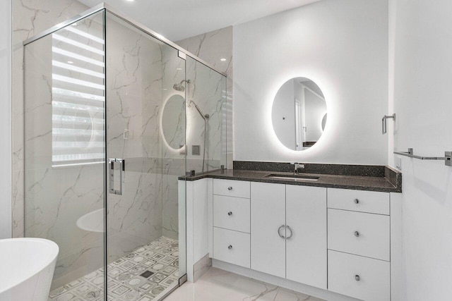 5779 Regency Cir W, Boca Raton, FL 33496 - bathroom with marble look tile flooring, vanity, a soaking tub, and a marble finish shower