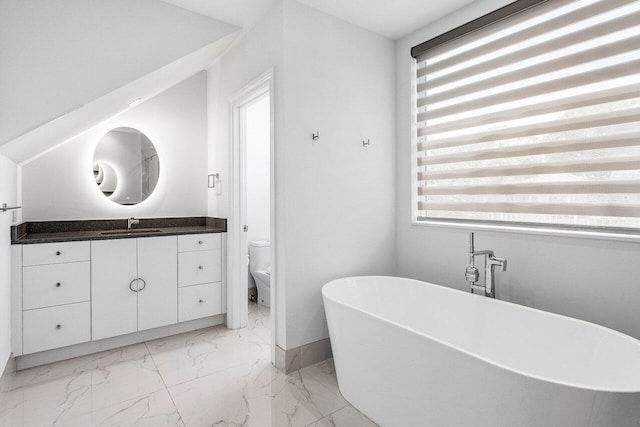 5779 Regency Cir W, Boca Raton, FL 33496 - full bath with a soaking tub, toilet, marble look tile flooring, vanity, and baseboards