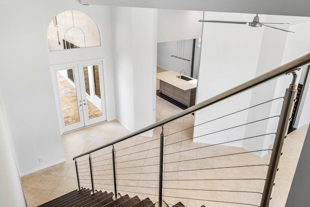 5779 Regency Cir W, Boca Raton, FL 33496 - stairway with french doors, baseboards, and tile patterned floors