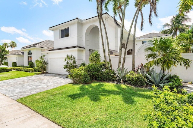 5779 Regency Cir W, Boca Raton, FL 33496 - view of front of property with stucco siding, a front lawn, decorative driveway, a garage, and a tiled roof