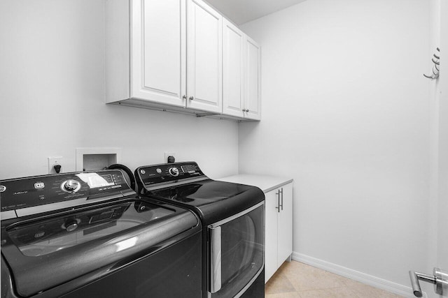 5779 Regency Cir W, Boca Raton, FL 33496 - washroom featuring separate washer and dryer, cabinet space, baseboards, and light tile patterned floors