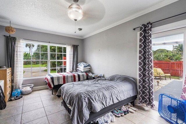 803 Mallard Dr, Delray Beach, FL 33444 - tiled bedroom featuring ornamental molding and ceiling fan