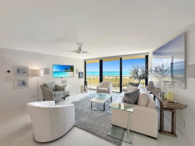 3000 N Ocean Dr Unit 4-D, Singer Island, FL 33404 - tiled living room featuring expansive windows, baseboards, and a ceiling fan