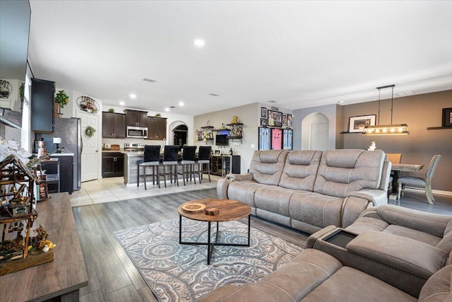3313 SW Ludlow St, Port Saint Lucie, FL 34953 - living area featuring arched walkways, recessed lighting, and light wood-type flooring